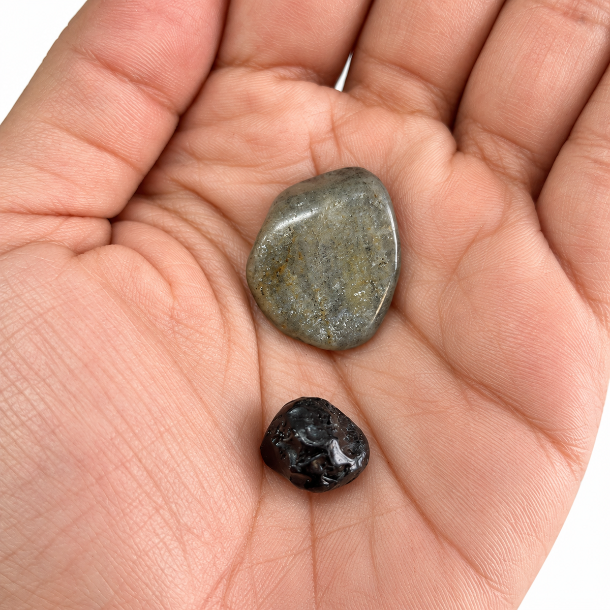 Apache Tears and Labradorite in an open palm for size